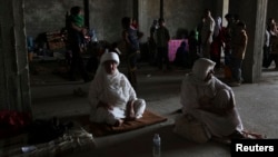 Displaced members of the Yazidi minority, fleeing the violence in the Iraqi town of Sinjarl west of Mosul, take refuge at in Dohuk Province on August 7.