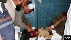 A Pakistani paramedic gives treatment to an injured victim following a suicide vehicle bombing attack in northwest Pakistan.