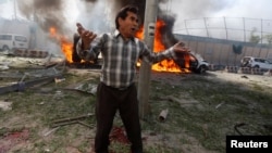 An Afghan man reacts at the site of the blast in Kabul on May 31.