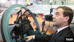 Russian President Dmitry Medvedev sits in the cockpit of a fighter jet during a visit to a jet manufacturing plant in Irkutsk.