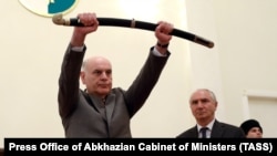 Aslan Bzhania holds a sword during his inauguration ceremony in Sukhumi on April 23.