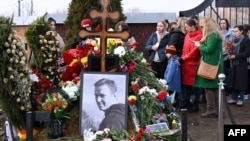 People pay tribute at the grave of late Russian opposition leader Aleksei Navalny in Moscow on the day of Russia's presidential election on March 17. 