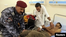 A wounded army recruit is transferred to a hospital after a bomb attack in Baghdad today.