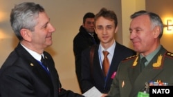 Admiral Giampaolo Di Paola (left), chairman of the NATO Military Committee, greets Russian Chief of Staff General Nikolai Makarov in Brussels.