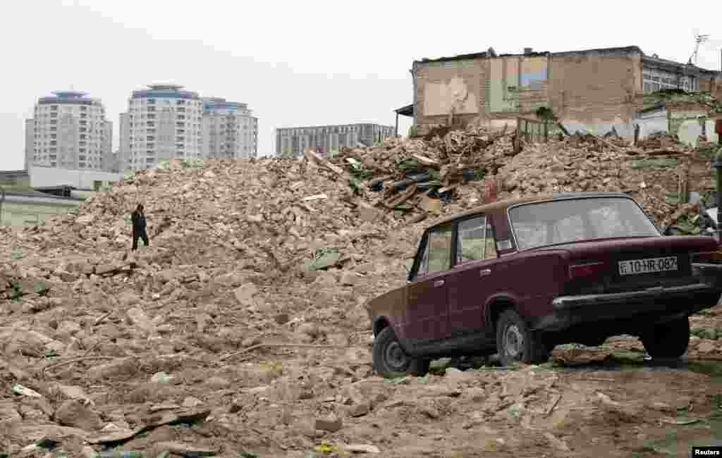 A man walks on the rubble of demolished houses in Baku. Entire districts were razed in the development of new landmarks in the city of 2 million.&nbsp; &nbsp;