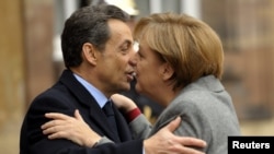 Fraench President Nicolas Sarkozy (left) and German Chancellor Angela Merkel have been working so closely in recent weeks that commentators have taken to calling them "Merkozy."