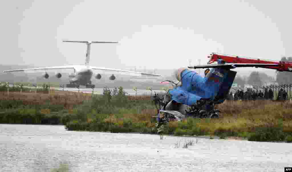 Investigators inspect the debris of the plane at the crash site.