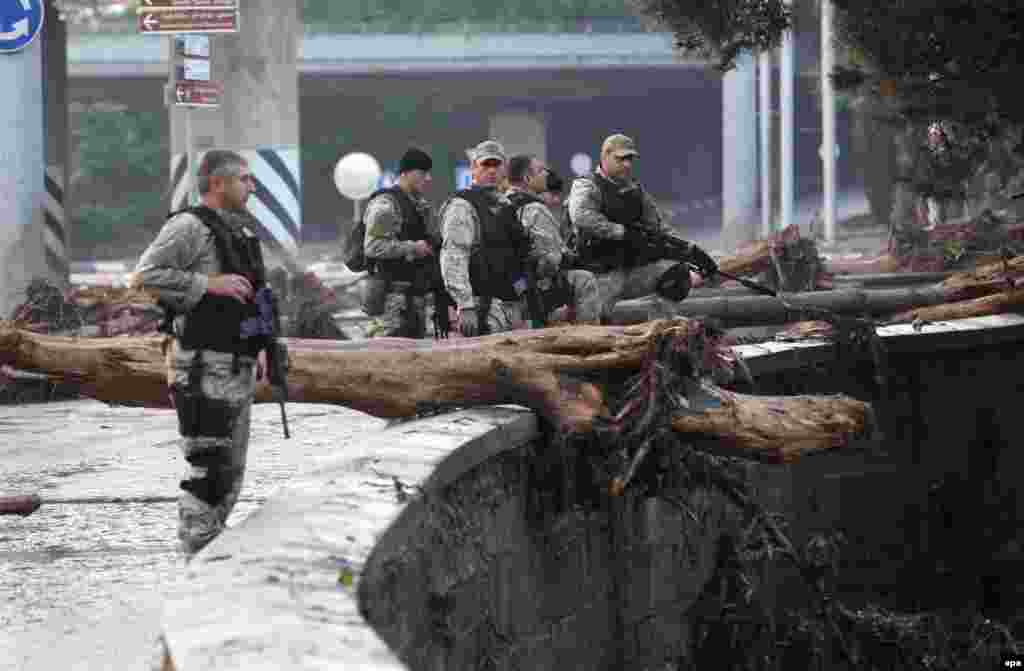 A handout picture provided by the Georgian prime minister's press office shows armed policemen patrolling a flooded street in Tbilisi.