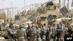 U.S. soldiers pack at the Joint Security Station Comanche base south of the Al-Sadr City district in Baghdad