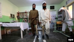 Afghans who were maimed in land mine blasts practice walk with prosthetic limbs at a Red Cross center in Herat. (file photo)