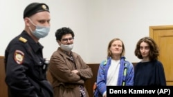 Doxa magazine editors (from left) Armen Aramyan, Natalya Tyshkevich, and Alla Gutnikova wait for a court session in Moscow on April 14, where their "minute of freedom" would be ordered.