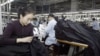 Workers make cotton trousers for the foreign and domestic market at a factory in Ningbo