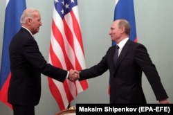 Then-Vice President Joe Biden (left) shakes hands with then-Prime Minister Vladimir Putin during their meeting in Moscow in March 2011.