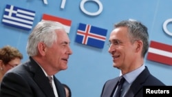 U.S. Secretary of State Rex Tillerson (left) greets NATO Secretary-General Jens Stoltenberg during a NATO foreign ministers meeting at the alliance's headquarters in Brussels in March 31.