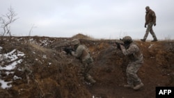 Ukrainian soldiers conduct exercises at a training ground near the front line in the Donetsk region on February 23.