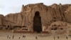 Afghan boys play soccer in front of the empty seat of one of two Buddha statues destroyed by the Taliban in 2001 in Bamiyan Province.