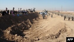 Demonstrators protest outside Camp Ashraf near the Iranian border in December 2011.