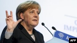 German Chancellor Angela Merkel gestures during her speech to the opening session World Economic Forum.