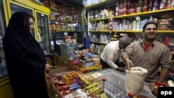 An Iranian woman complains to a merchant about the rising rice prices in Tehran,