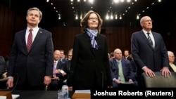 FBI Director Christopher Wray (left to right), CIA Director Gina Haspel, and Director of National Intelligence Dan Coats arrive with other U.S. intelligence community officials to testify before a Senate Intelligence Committee hearing on "worldwide threats" in Washington on January 29.