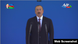 Azerbaijani President Ilham Aliyev speaks at a military parade on June 26. 