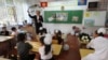 A Kyrgyz teacher leads a class of first-graders in the village of Besh-Kungey near Bishkek.