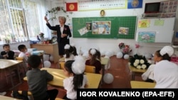 A Kyrgyz teacher leads a class of first-graders in the village of Besh-Kungey near Bishkek.