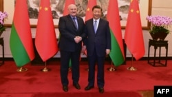 Belarusian strongman Alyaksandr Lukashenka (left) meets with Chinese President Xi Jinping in Beijing on December 4. 