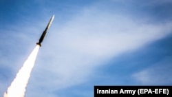 An Iranian air-defense missile is fired during drills in an undisclosed location in Iran. 