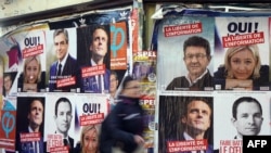 Freedom of information is urged on French presidential campaign posters in Paris.