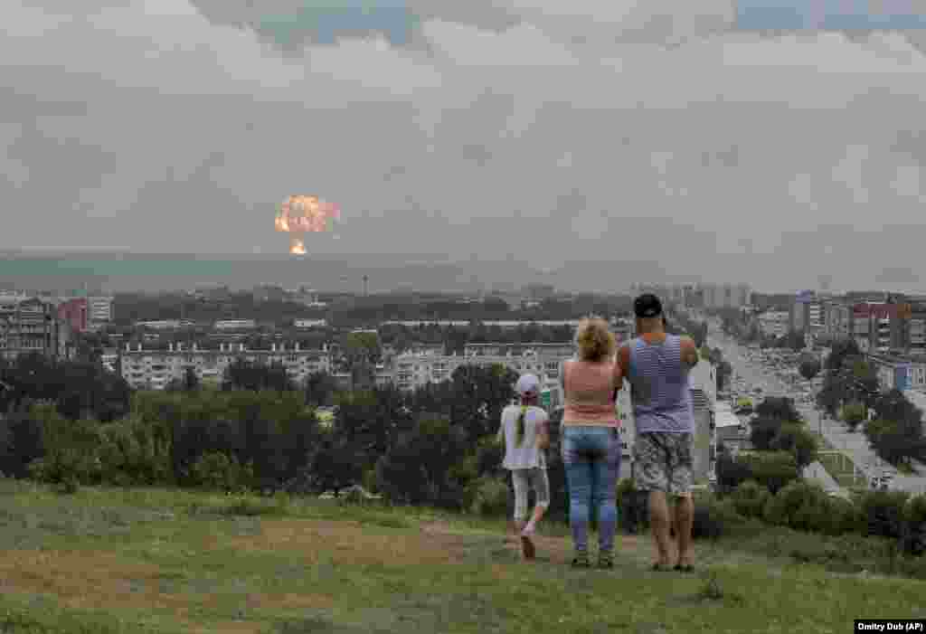 A family watches the explosions from afar.