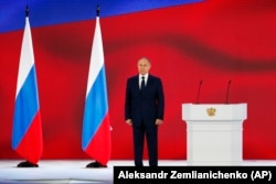 Russian President Vladimir Putin listens to the national anthem after his annual state-of-the-nation address in Moscow on April 21.