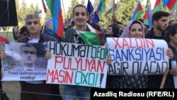 Opposition activists with signs at Baku demonstration