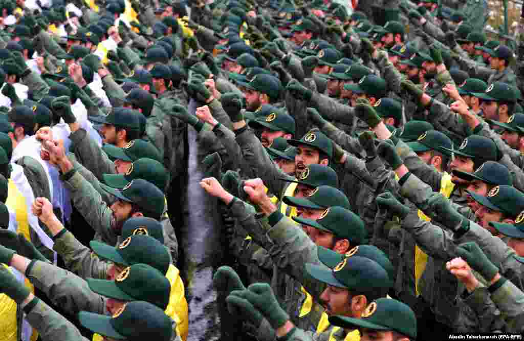 Members of the Islamic Revolutionary Guards Corps raise their fists while shouting slogans on Azadi (Freedom) Square in Tehran.