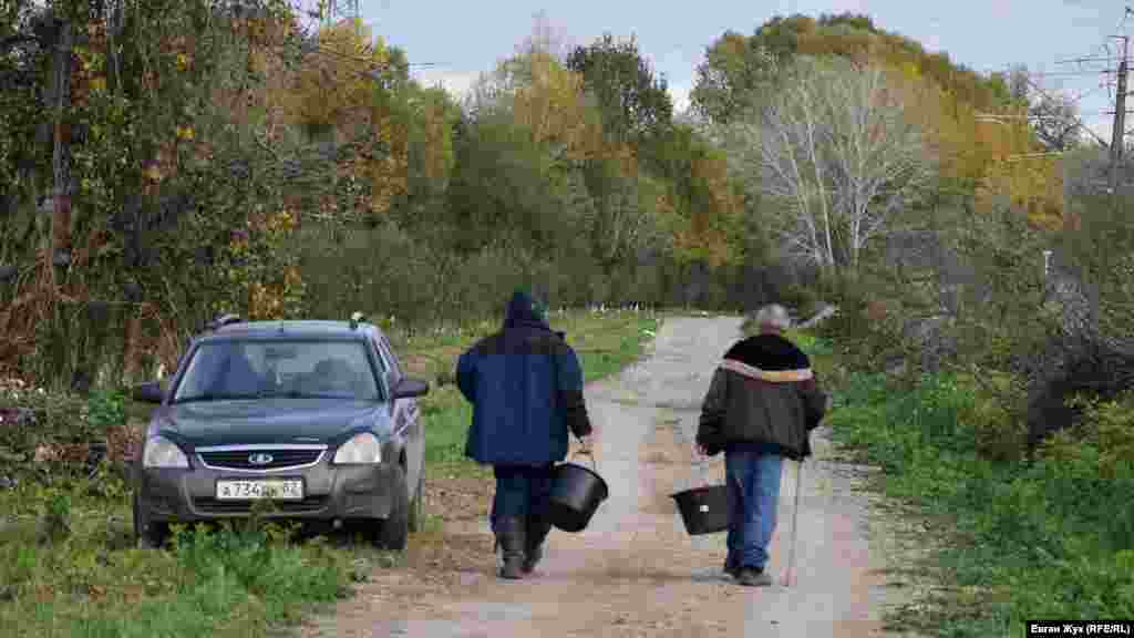 Грибники идут по дороге в лес