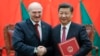 Chinese President Xi Jinping (right) shakes hands with Alyaksandr Lukashenka at a signing ceremony during the Belarusian leader's visit to Beijing in 2016. 