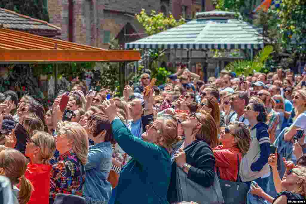 Crowds gather under the tower in the summer of 2019. &nbsp; Every hour, doors open on the tower to reveal mannequins enacting a kind of &ldquo;circle of life.&rdquo;