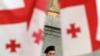 A Georgian policeman watches a mid-May opposition rally from near the parliament building.