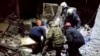 Emergency workers retrieve bodies from the rubble of a building following a missile strike in Lysychansk on February 3.