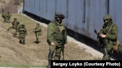 Russian soldiers standing guard in front of a Ukrainian military base in Crimea during the takeover in March 2014.