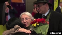 Leyla Yunus and her husband, Arif (right rear), were greeted by their daughter, Dinara Yunus