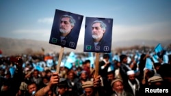 Supporters of Afghan presidential candidate Abdullah Abdullah hold posters of him during an election rally in Parwan Province on March 20.