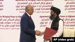 The Doha agreement between the Taliban and the United States was signed by the U.S. Special Representative for Afghanistan Reconciliation Zalmay Khalilzad (left) and Taliban leader Mullah Baradar Abdul-Ghani on February 29, 2020.