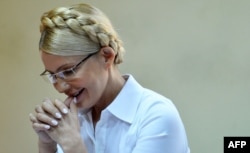 Yulia Tymoshenko smiles as she listens to the judge in Kyiv's district court during her trial on July 15, 2011.