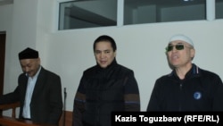 Kenzhebek Abishev, Oralbek Omyrov, and Almat Zhumagulov appear in court in October. 