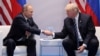 U.S. President Donald Trump shakes hands with his Russian counterpart, Vladimir Putin, at their first official meeting in Hamburg in July.