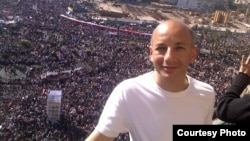 Khaled Fahmy, history professor at the American University in Cairo, stands in front of crowds in Egypt's Tahrir Square.