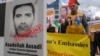 Iranian opposition activists protest with poster depicting Iranian official Asadollah Assadi in Brussels in 2018.