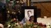 People lay flowers at the grave of Russian opposition politician Aleksei Navalny following his funeral in Moscow on March 1.