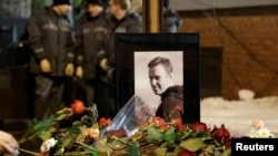 People lay flowers at the grave of Russian opposition politician Aleksei Navalny following his funeral in Moscow on March 1.